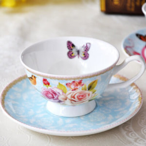 butterfly and pink flower decorated blue base cup and saucer set