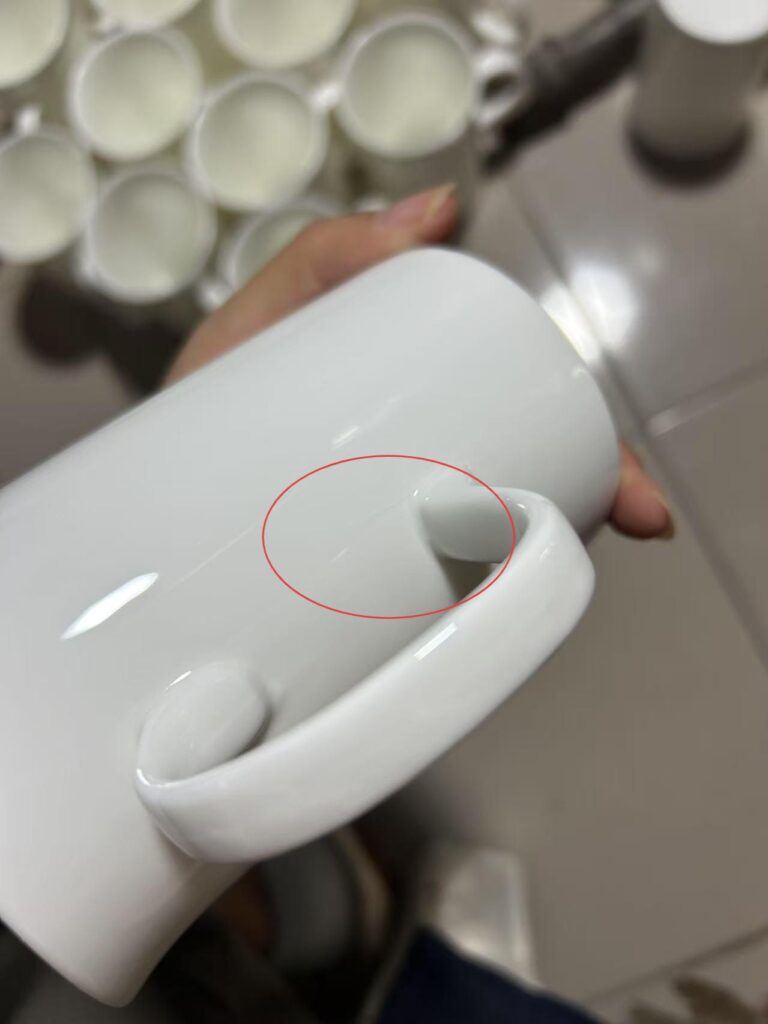 A close-up of bone china tableware showing subtle crazing cracks on the glazed surface