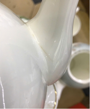 small crazing crack at the joint of a teapot spout
